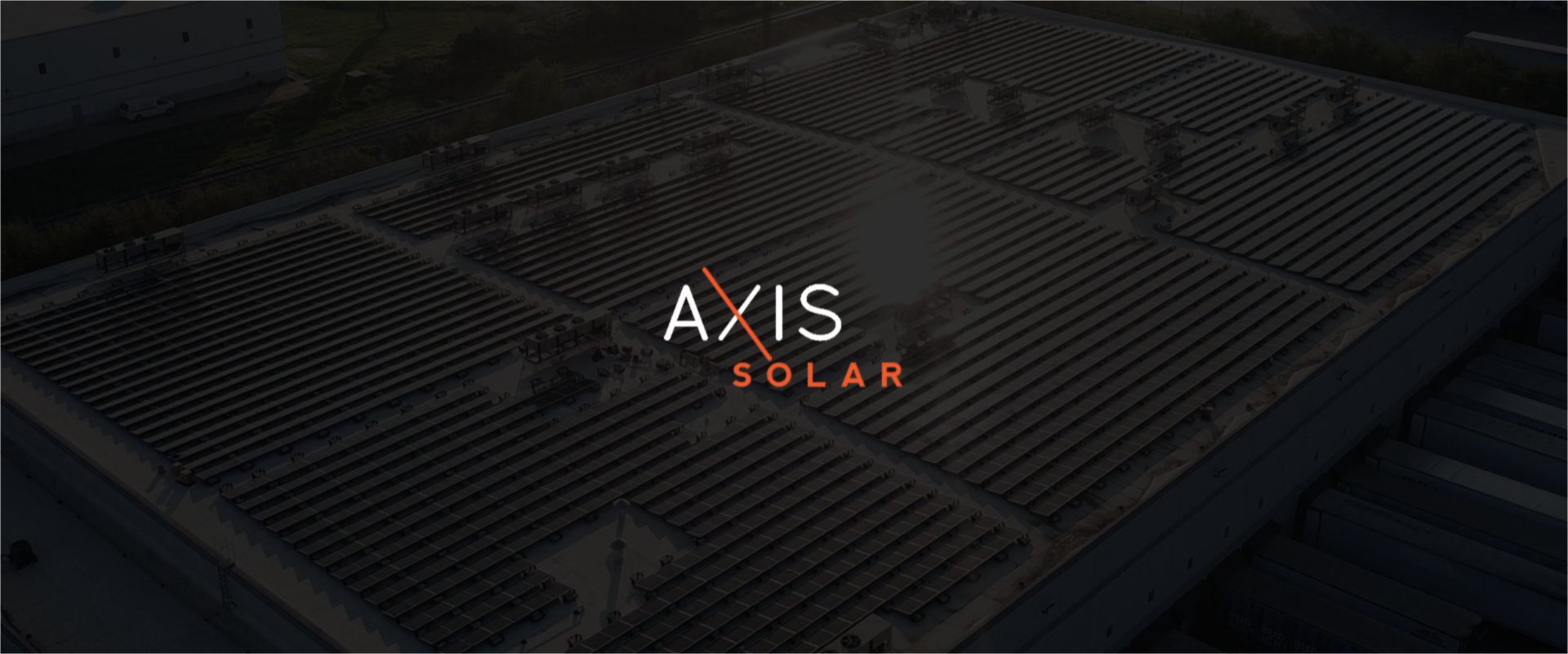 Axis Solar logo on a photo of commercial solar panels that has been darkened so the logo is readable.